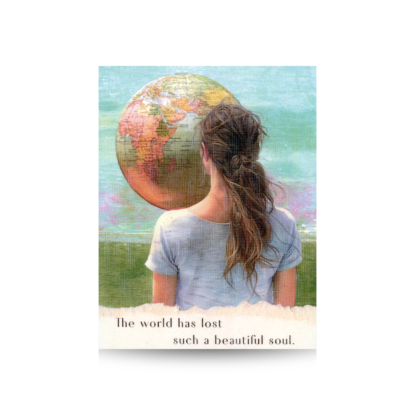 This sympathy card features a woman with long brown hair wearing a grey t shirt looking away at a vintage globe suspended in the sky. The backdrop is a hand-painted scene of green ground and moody sky of blues and pinks. The phrase "The world has lost such a beautiful soul" appears at the bottom in an area of torn paper.