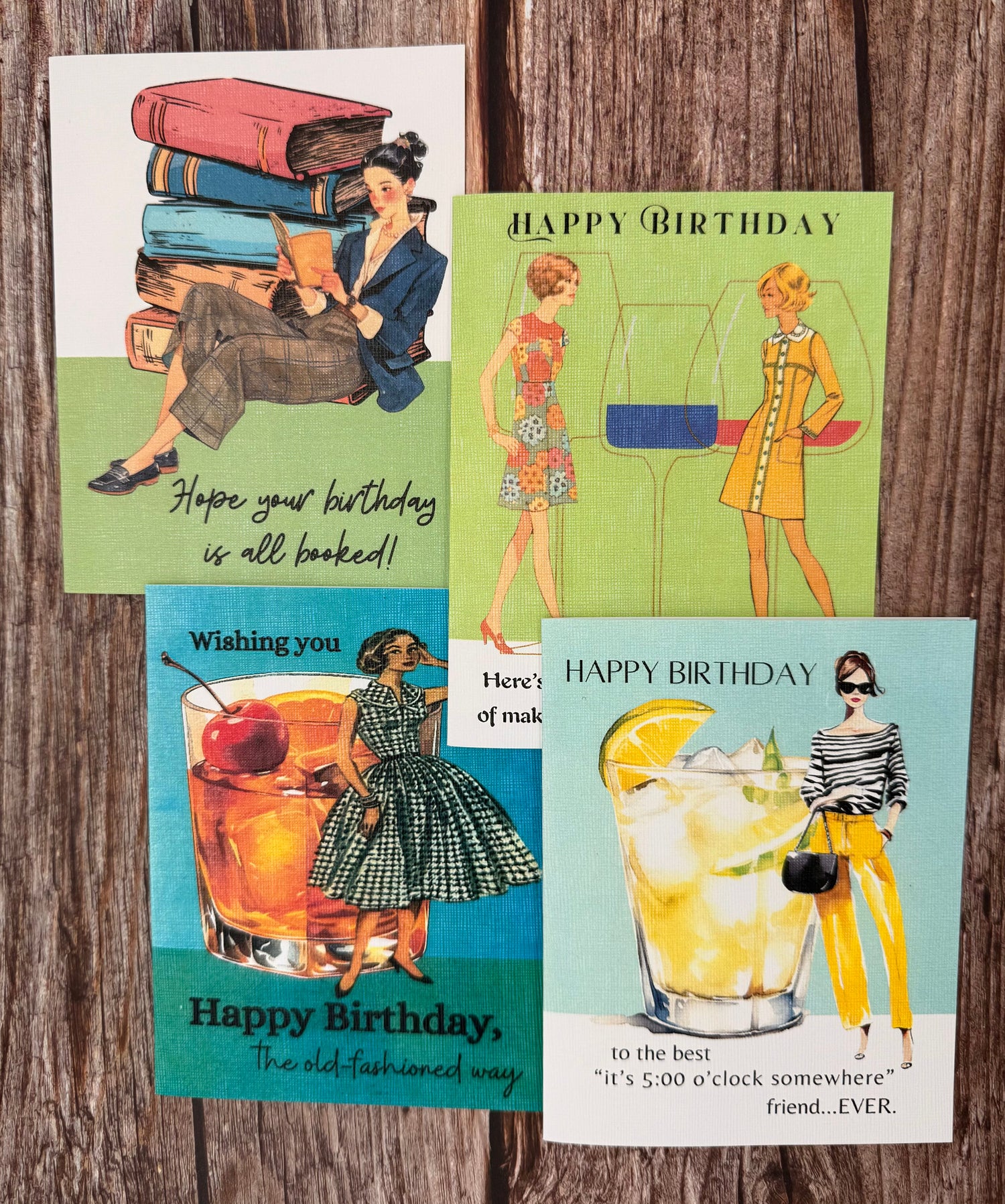 INN RETROspect's birthday card collection displayed on a wooden table. These cards feature strong female characters displayed on fun birthday cards. 