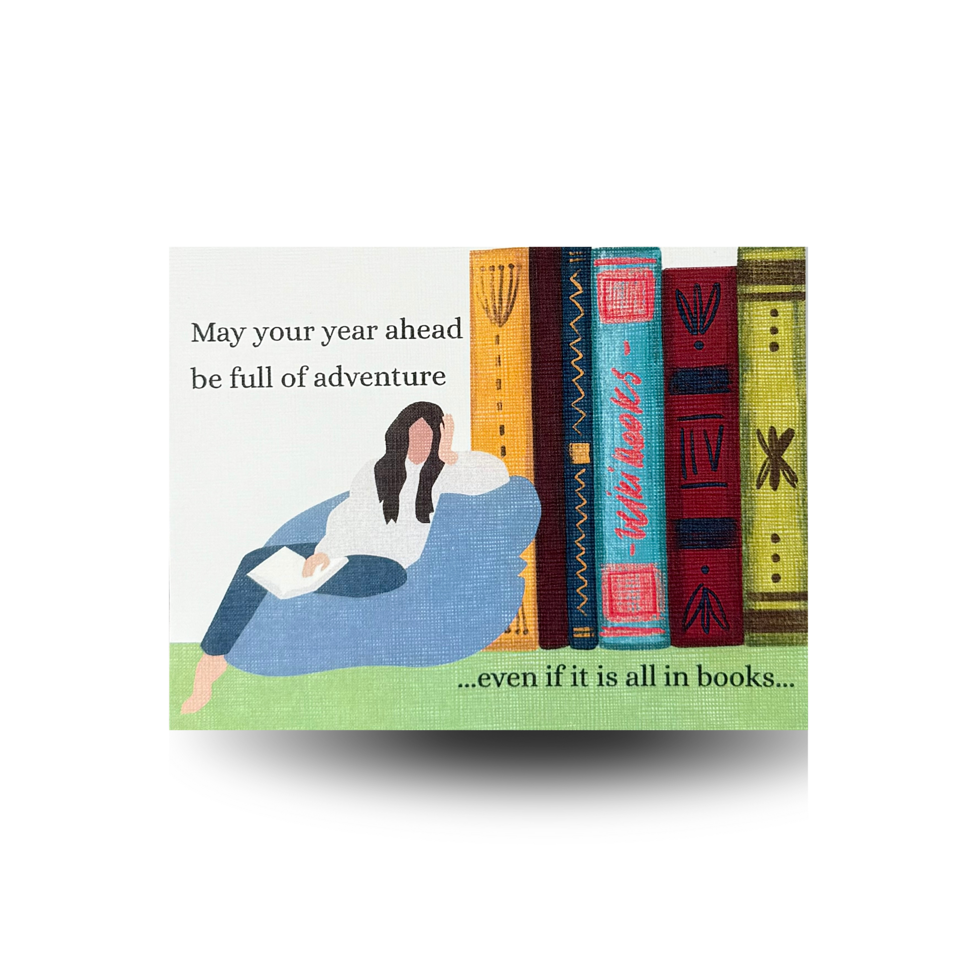 This birthday card features a modern woman lounging on a blue beanbag chair while reading.  There is an oversized stack of books beside her.  The greeting "May your year ahead be full of advance...even if it is all in books..." is written to the side and at the bottom of the scene. 