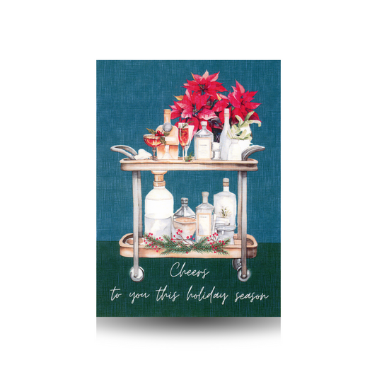 Bar cart with cocktails and a poinsettia on a dark teal blue and green background with 'Cheers to you this holiday season' text.