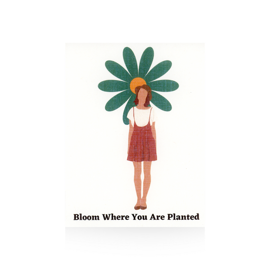 This greeting card features a white background and a modern woman in a short overall brown dress with a hat on.  There is a large retro-styled flower in green with a yellow center behind the girl's head.  The message "Bloom where you are planted" is at the bottom of the card