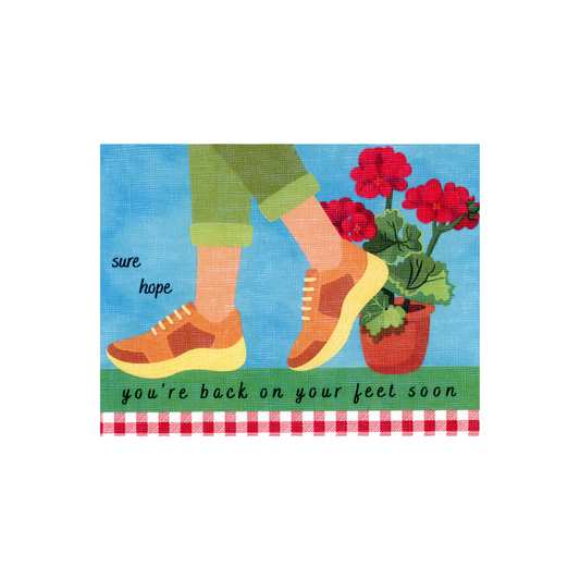 This get well card features the saying "sure hope you're back on your feet soon" and displays the bottom part of a woman's pants with rolled cuff and brown athletic shoes.  She is standing on green grass; there is blue sky behind her, a red geranium on the ground behind her, and a red gingham print border at the bottom of the card