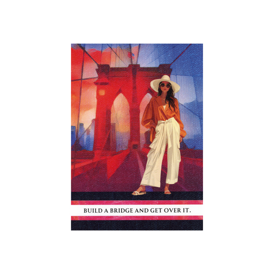 This art print is 5 x 7 inches.  It features a modern lady in white wide-legged pants and a rust-colored top, wearing sandals, a white hat and sunglasses.  She is standing on an abstract-looking Brooklyn bridge and is standing on the quote "Build a bridge and get over it."  