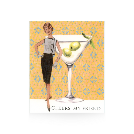 This greeting card features an oversized martini glass with two olives in it, sitting on a white base with a yellow and blue flowered background.  To the left of the martini glass is a vintage illustrated lady in a black sleeveless dress.  The greeting "Cheers, my friend" is written on the base of the card