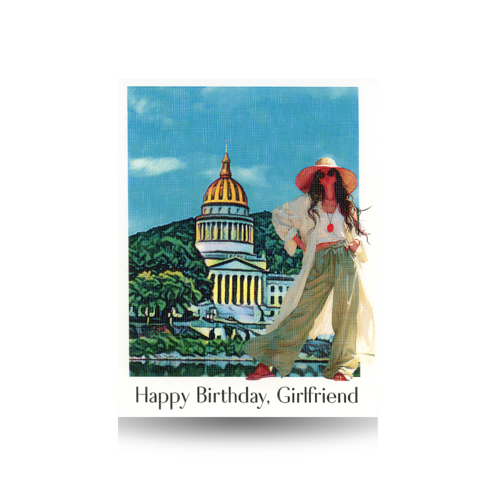 This birthday card features a scene of the West Virginia State Capitol in Charleston, West Virginia, with a modern woman standing in front of the scene.  She is wearing wide-legged green pants, a long tunic, and a cropped t-shirt.  She is wearing a floppy hat and sunglasses and sandals