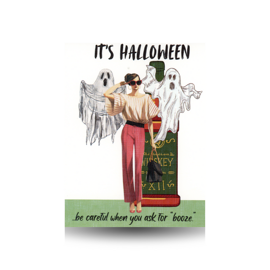 This Halloween card features the greeting "IT'S HALLOWEEN...be careful when you ask for booze" and shows a modern lady in pink pants and striped top, standing beside an oversized whisky bottle.  Two ghosts are flanking her.  She has dark hair and is wearing sunglasses.  She is standing on green ground.  The greeting appears at the top and bottom of the card