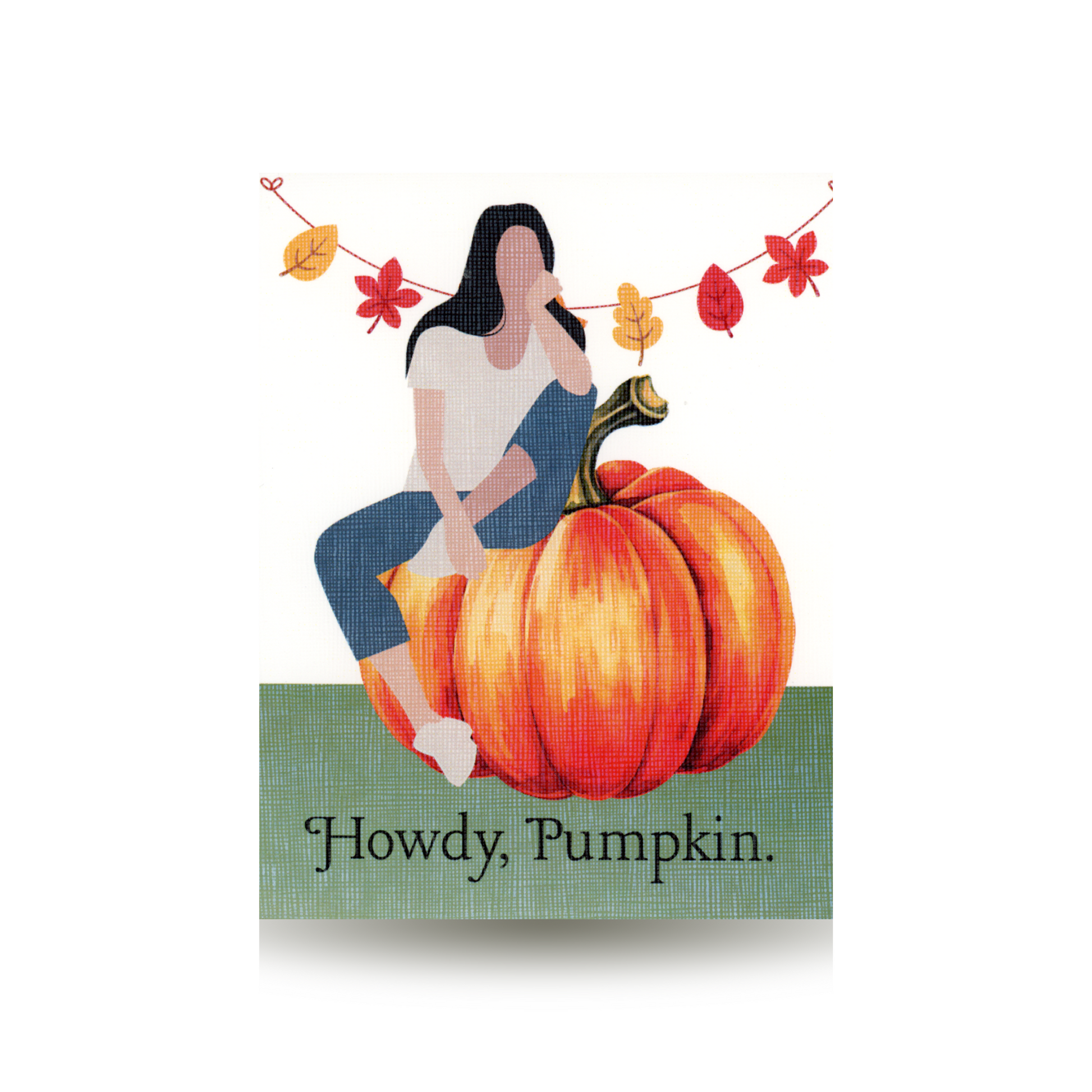 This card features a modern woman sitting atop a pumpkin.  She is wearing jeans and a white t-shirt.  She has long dark hair.  There is autumn bunting hanging behind her.  The ground is green and Hello Pumpkin is written on the bottom of the card.  The background is white.