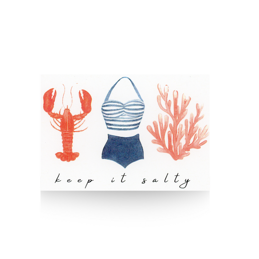 This notecard is printed on white paper and features watercolor illustrations of a lobster, a two piece vintage bathing suit and a piece of coral, all the same size.  Below the items is the message "keep it salty"