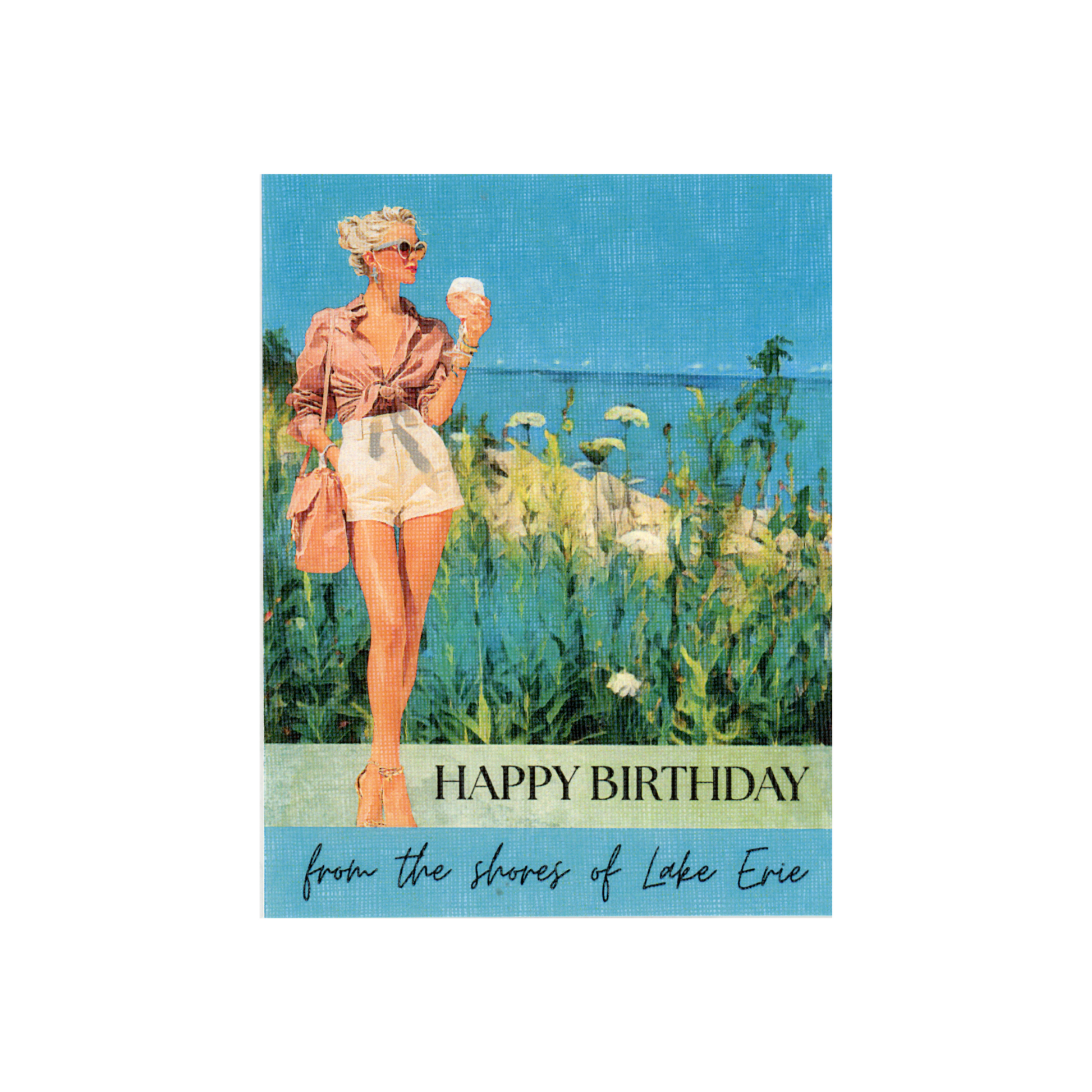 This birthday card features a scene from a lake with blue water and sky, shoreline of rocks and white wildflowers, with a woman in white shirts and a pink blouse tied at waist, standing to the side carrying a purse and holding a glass of wine.  She has blond hair and is wearing sunglasses.  The message "HAPPY BIRTHDAY from the shores of Lake Erie" is written on the bottom part of the card 