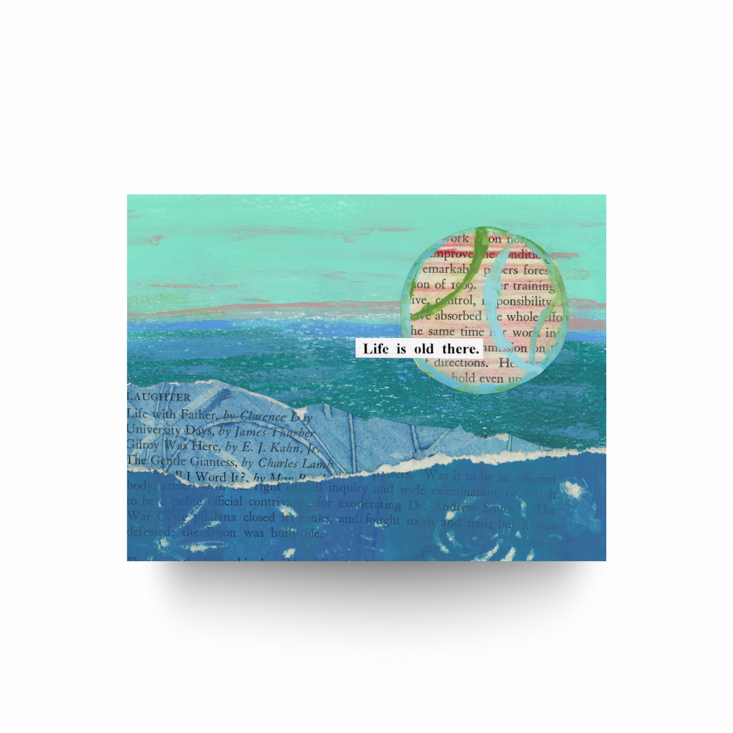 This notecard features a collage of hand-painted papers and old text in shades of green, have, and blue.  There is a large word sun in the top right hand corner and it is painted pink with lines of green and blue running through it.  The message "Life is old here" is written on a white cut out piece of paper and the message is intersecting the sun.