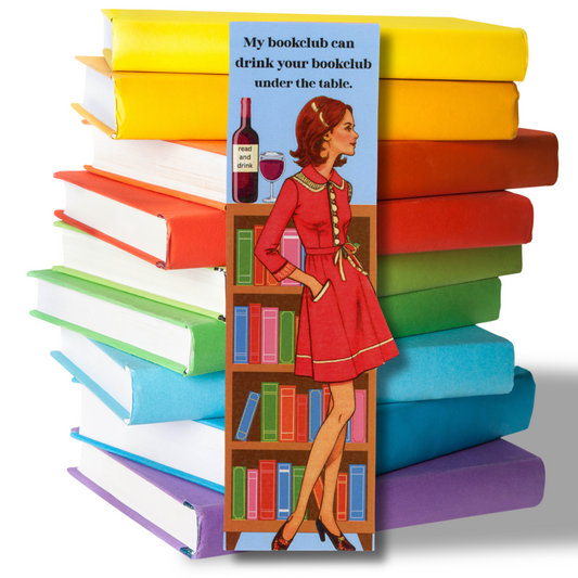 This photo shows a stack of brightly colored books with a book mark in front showing a vintage lady in a short red dress standing in front of a bookcase with a bottle of red wine on top.  The message is "My book club can drink your book club under the table."
