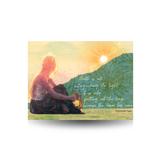 This sympathy card features a young woman with long blond hair wearing a dark skirt and light sleeveless top looking away at a sun setting over a mountain.  A lantern sits beside her.  The quote is "Death is not extinguishing the light it is only putting out the lamp because the dawn has come" and the quote is attributed to Rabandranath Tagore.