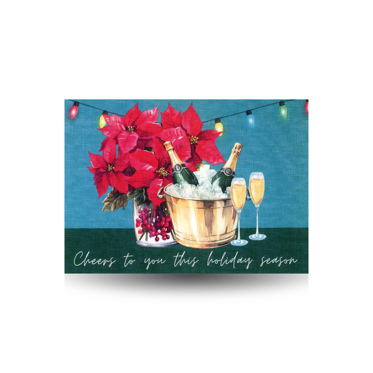Holiday card with poinsettias, champagne, and champagne glasses on a blue background with a string of lights behind.