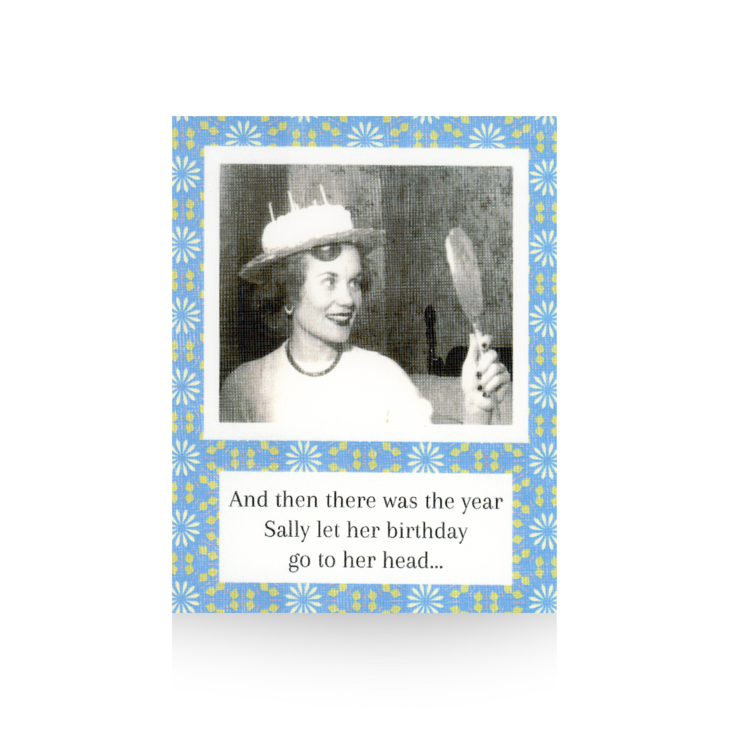 This birthday card features a vintage black and white phot of a lady looking in a hand-held mirror and she is wearing a birthday cake on her head.  The message "And then there was the year Sally let her birthday go to her head..." is written at the base of the card.  There is a blue-flowered background to the card
