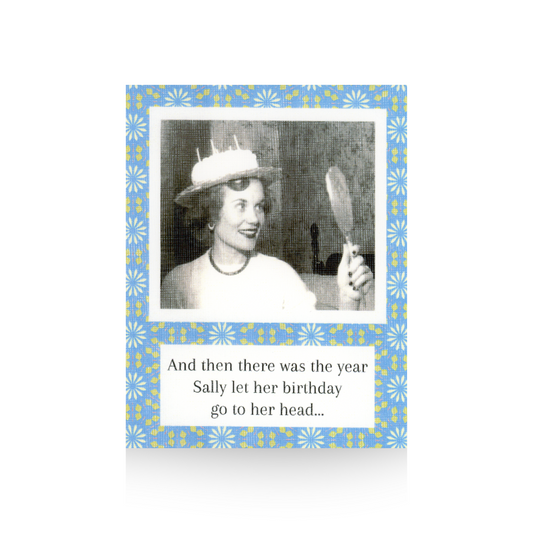 This birthday card features a vintage black and white phot of a lady looking in a hand-held mirror and she is wearing a birthday cake on her head.  The message "And then there was the year Sally let her birthday go to her head..." is written at the base of the card.  There is a blue-flowered background to the card