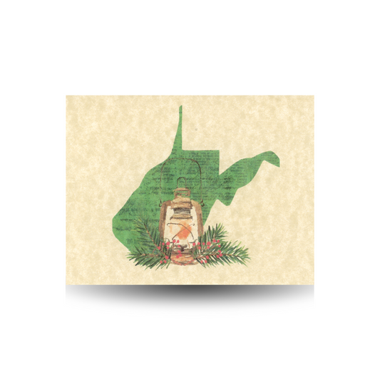 This note card features a green West Virginia state outline with a lantern sitting at its base, surrounded by pine and berries.  It is printed on tan parchment paper